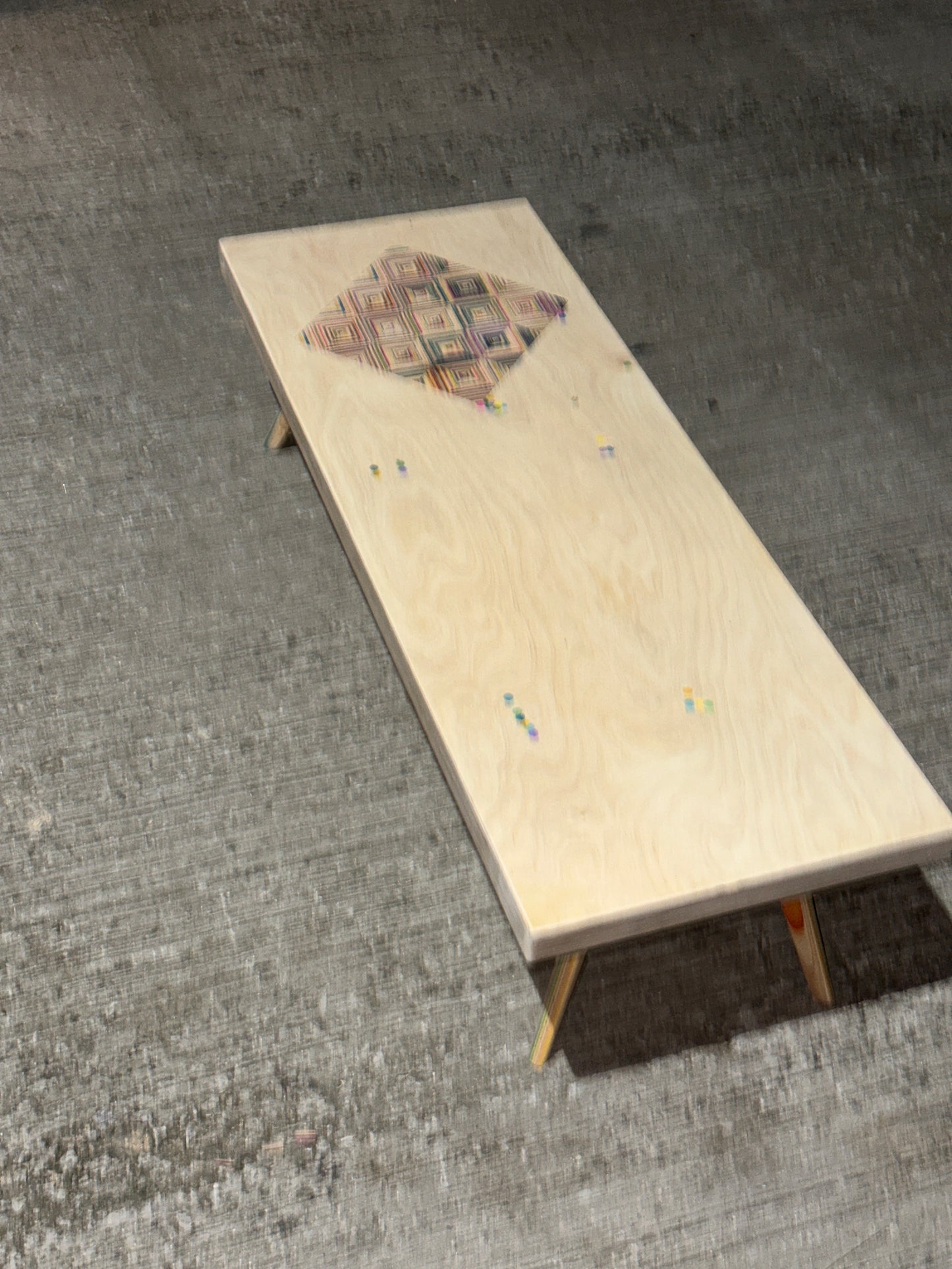 Birch plywood coffee table with geometric skateboard inlay and legs