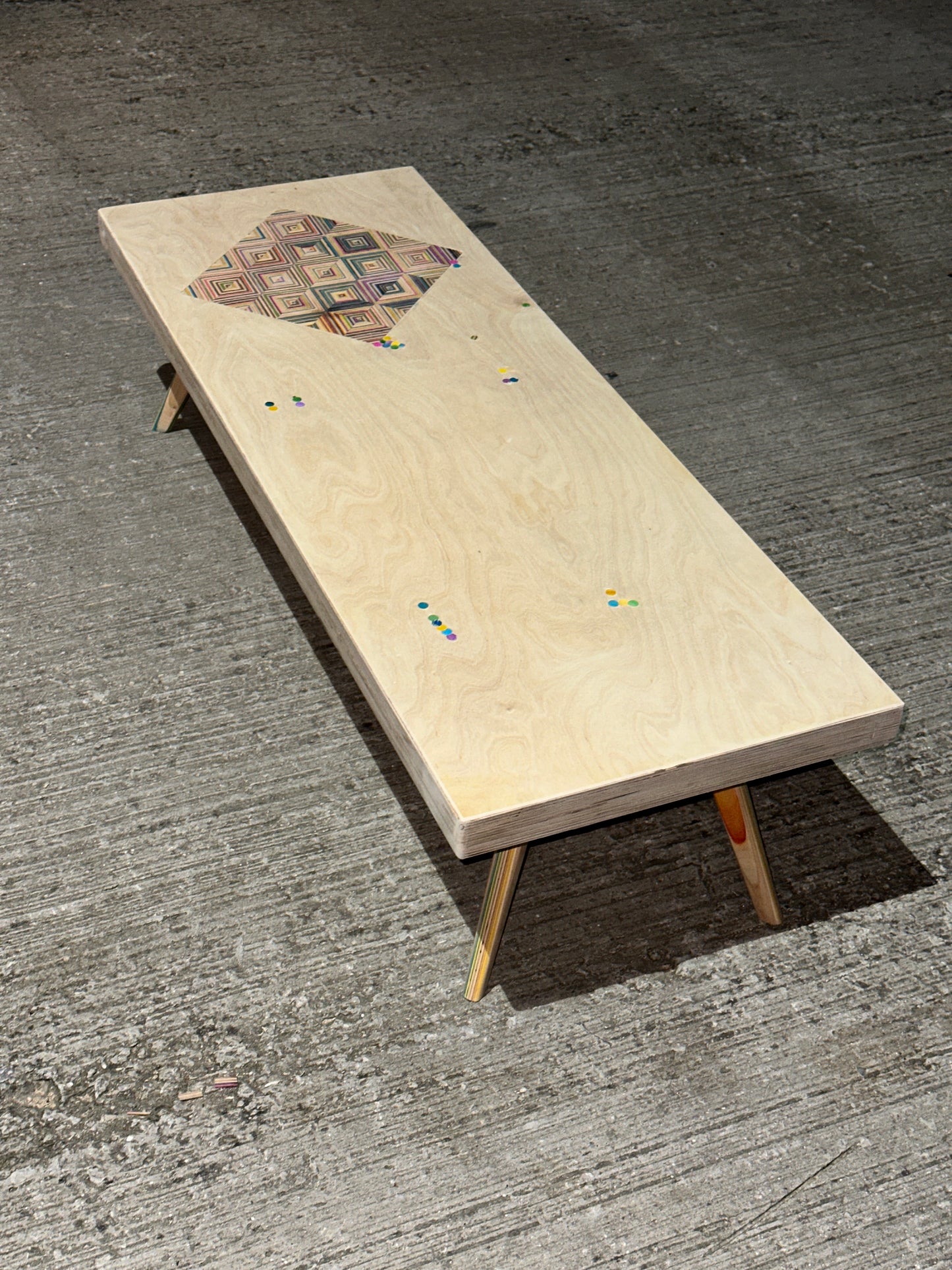 Birch plywood coffee table with geometric skateboard inlay and legs