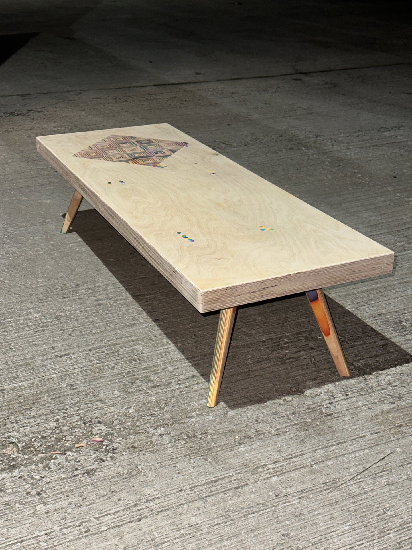 Birch plywood coffee table with geometric skateboard inlay and legs