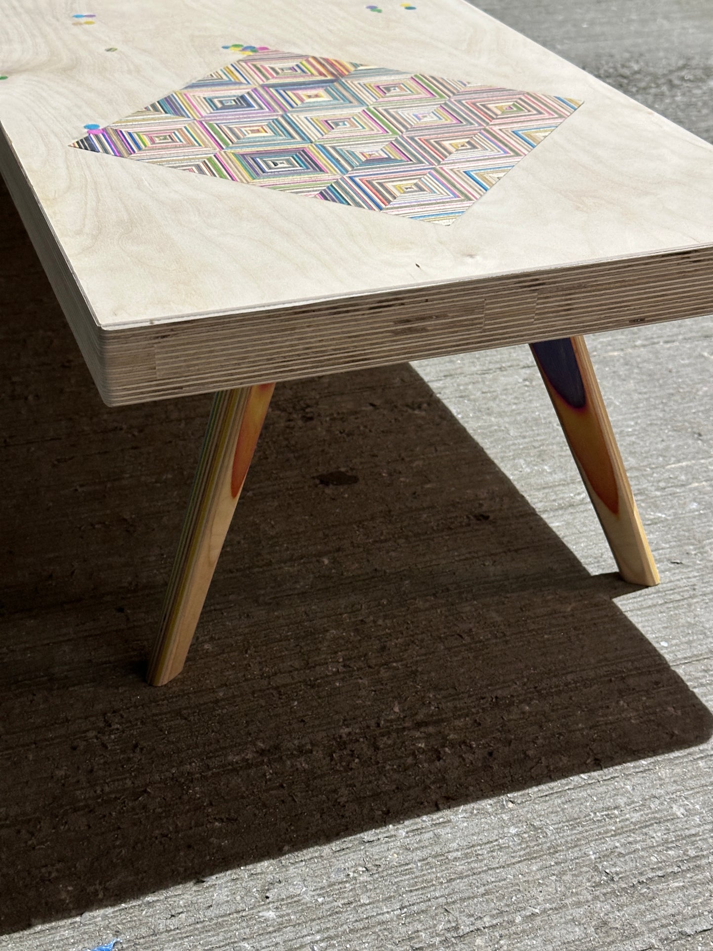 Birch plywood coffee table with geometric skateboard inlay and legs